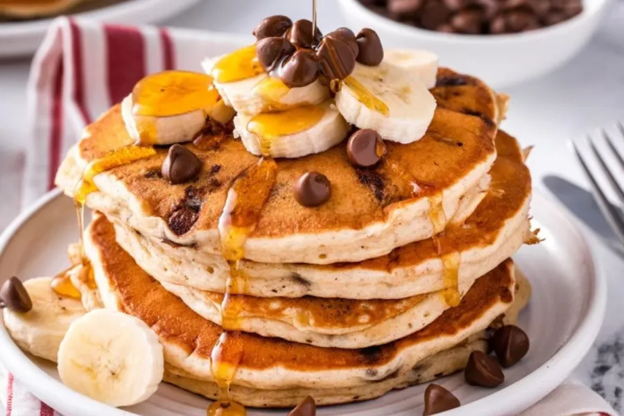 Pico Pica Rico | Chocolate Chip Banana Pancakes - Chocolate Chip Pancakes, topped with fresh Banana slices and drizzled with Golden Maple Syrup.